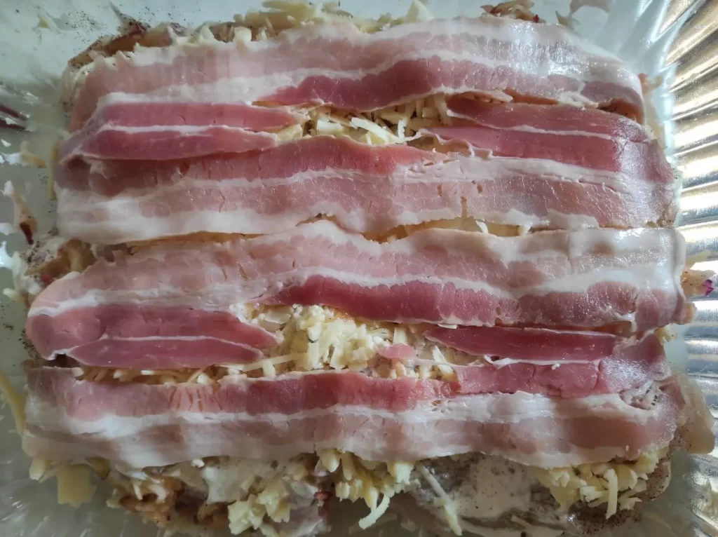 The second bacon layer on top of the dish